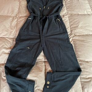 Black cotton jumper with zippers and buckles in brass